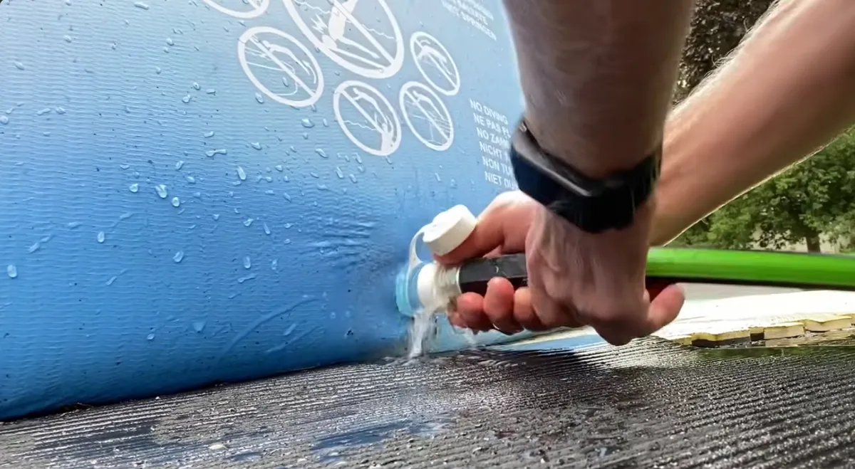 Tuyau d'arrosage raccordé à la valve de vidange d'une piscine hors sol Intex